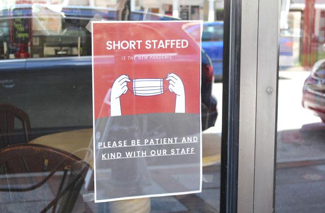 Help wanted signs are on many storefront windows, like this one in downtown Kissimmee. PHOTO BY KEN JACKSON