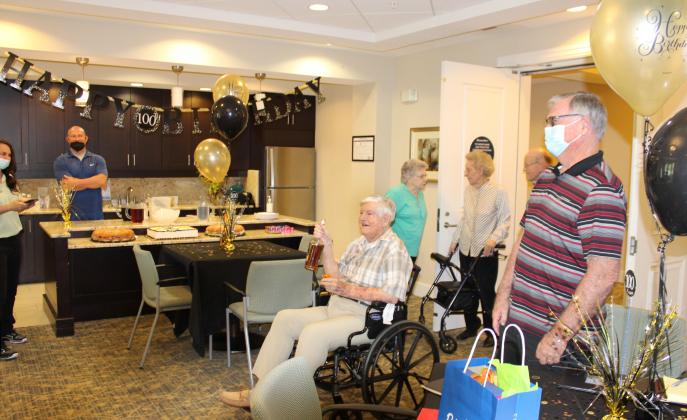 Harry Nivens enjoys a Calvados toast at his 100th Birthday celebration Saturday. PHOTO/TERRY LLOYD