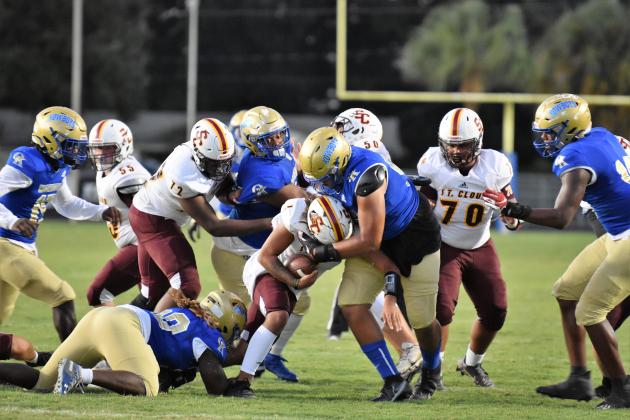 A bevy of Osceola defenders corals St. Cloud running back Brandon Near during Monday's 56-0 win.  The Kowboys recorded 12 tackles-for-loss and allowed just 50 net offensive yards in the game. PHOTO/JANA STULTZ