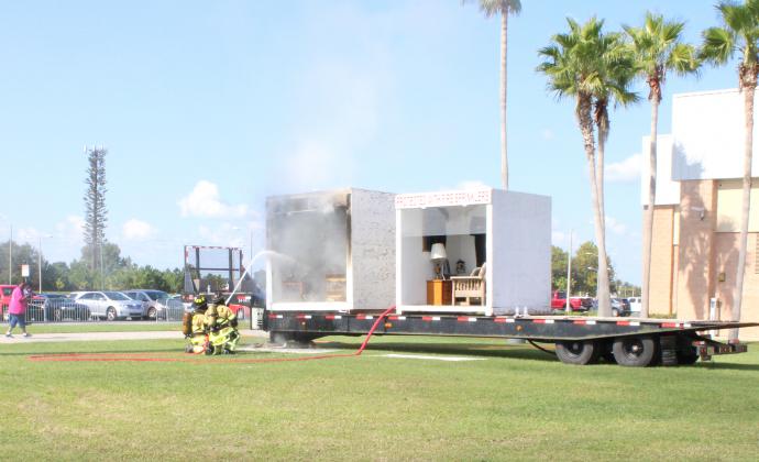 Firefighters demonstrate the effectiveness of sprinklers at Saturday's Fire Safety Fest. PHOTO/TERRY LLOYD