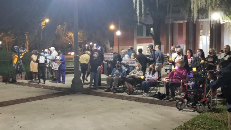 A group of local residents gathered at Thursday's vigil to remember the happenings of Jan. 6, 2021. PHOTO/KEN JACKSON