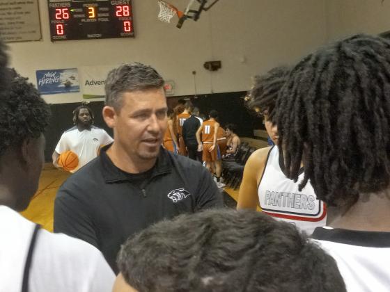 Gateway Coach Travis James addresses his team during a third-quarter time out of Thursday's 62-58 win over Harmony.