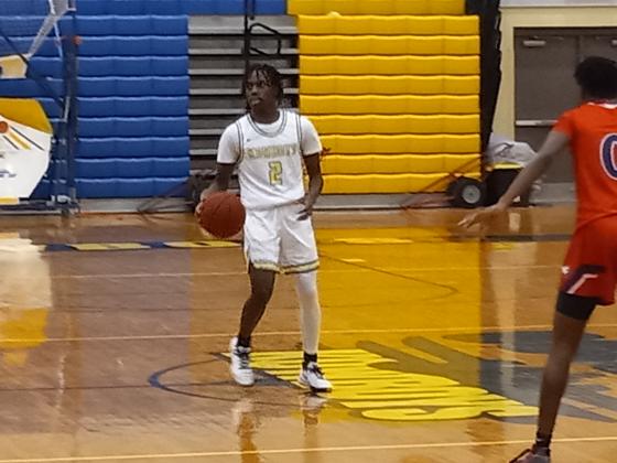 Chris Combs (2) brings the ball up court in the third quarter in Osceola's 55-25 OBC-clinching win Friday over Poinciana.  PHOTO/DAN PEARSON