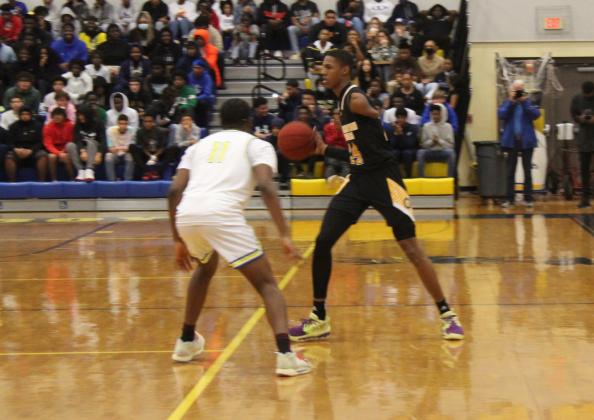 Life Academy Christian's Hansel Emmanuel brings the ball upcourt guarded by Osceola's Sean Combs Thursday. PHOTO/KEN JACKSON