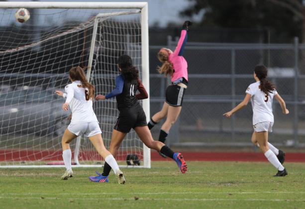 St. Cloud fires a shot past Harmony goalie Olivia Godfrey in Friday's District 6A-7 semifinal match. PHOTO/ROB HERBERT