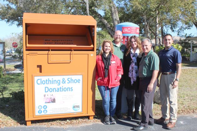 Textile donation boxes, like this at St. Cloud Levee Liquors and Gas, were put in place Thursday. At the Levee location is store owner Dana Wells, ATRS Marketing Manager Brian Papenfuss, Libby’s Legacy Executive Director Tracy Harris and ATRS Community Relations Advocate Gary Tolley.