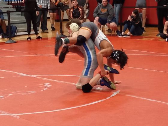 PHOTO/J. DANIEL PEARSON: Osceola’s Anderson Heap (bottom) works to reverse Harmony’s Rey Ortiz in the Orange Belt Conference finals of the 128-pound weight class.