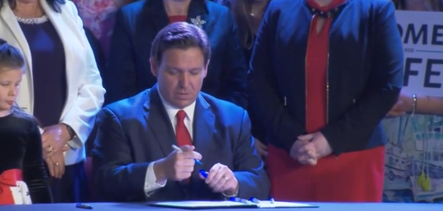 While in Kissimmee April 14, Gov. Ron DeSantis signs a bill banning abortions in Florida past the 15th week of pregnancy, to go into law July 1. PHOTO VIA WEBCAST