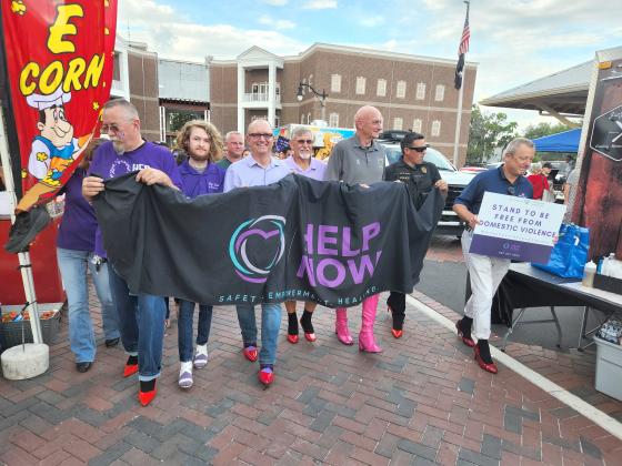 A parade of males walked “A mile in her shoes” during the April 27 St. Cloud Monthly Market downtown to bring awareness to domestic and sexual violence. PHOTO/KEN JACKSON