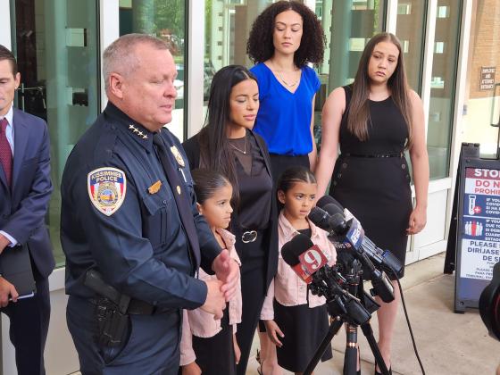 Kissimmee Police Chief Jeff O'Dell and the family of slain Officer Matthew Baxter speak with the media after Friday's sentencing