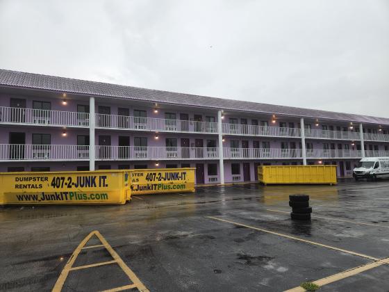 Industrial dumpsters fill the parking lot Friday at the Magic Castle Inn and Suites on West U.S. 192 Friday. PHOTO/KEN JACKSON