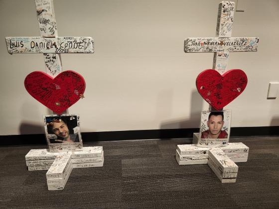 The crosses for Kissimmee beauty shop owners Luis Conde and Juan Rivera Velasquez were placed side-by-side at a Pulse victim memorial last weekend at the Orange County Regional Historical Center. PHOTO/KEN JACKSON