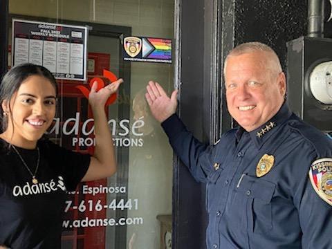 Jailene Espinosa of the Adanse dance studio on Broadway in downtown Kissimmee shows off its Safe Space sticker with KPD Chief Jeff O'Dell.