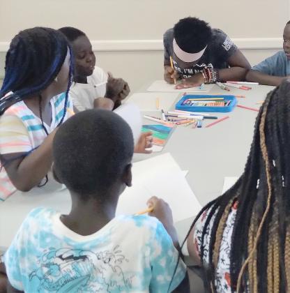 SUBMITTED PHOTO Children work on customized art projects in a June session of the WYE Project at the Marydia community center. The project, initially funded by an anonymous donor, seeks local partners to become a recurring program for underprivileged children.