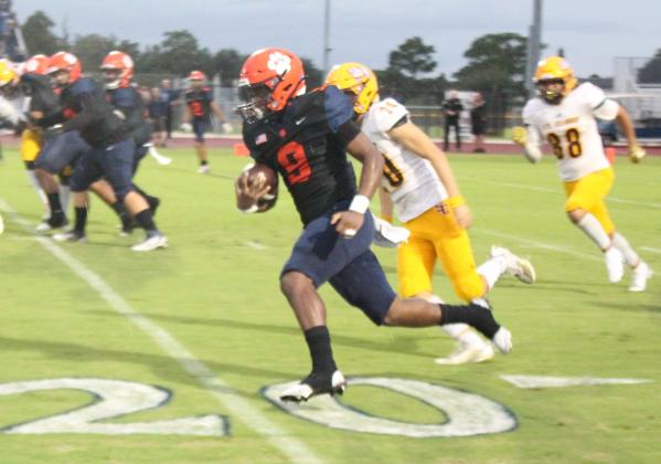Churandy Duvall rumbles for a chunk of his 226 rushing yards Friday as the Tigers rolled up 549 yards of offense Friday. PHOTO/KEN JACKSON