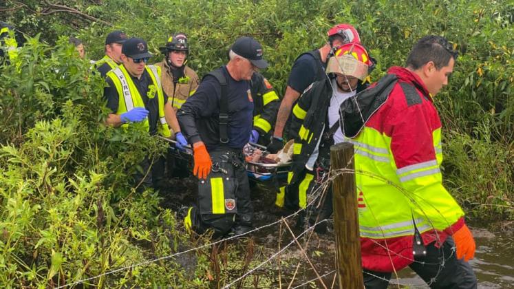 Osceola County firefighters remove a victim from Friday's plane crash scene. PHOTO/OSCEOLA COUNTY FIRE RESCUE EMS