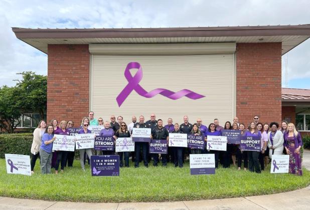 Help Now, the certified domestic violence center that has provided services for survivors and the children who witness domestic violence in Osceola County for the past 39 years, provided signs and other purple Domestic Violence Awareness Month-themed ribbons, badges and shields. PHOTO/HELP NOW OSCEOLA