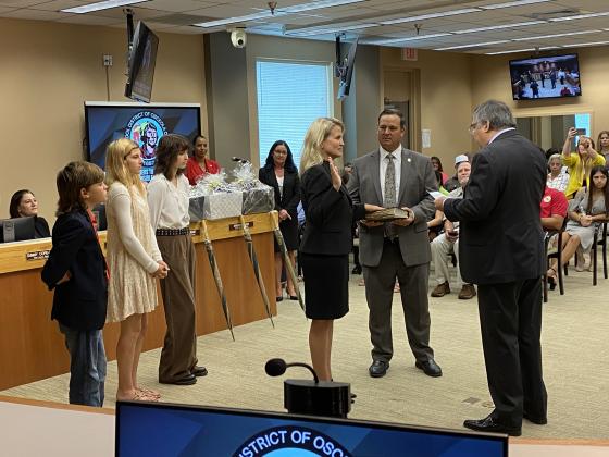 With Board Chair Terry Castillo (in red) looking on, School Board member Erika Booth is sworn in Tuesday, and was named Board vice chair. PHOTO/JANAE MUCHMORE