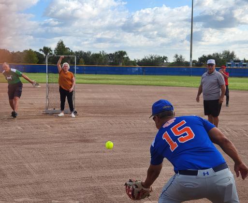 Steve Viti (left) and Donna Woodsby throw out the first pitch of the 2022-23 Osceola Senior Softball League. PHOTO/KEN JACKSON