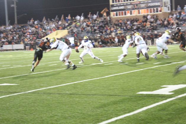 Osceola quarterback David Buggs rolls out early in the second quarter, and would hit Bo Mascoe on this play for a touchdown pass that gave the Kowboys an early lead Friday over Lakeland in the Class 4S state semifinal. PHOTO/KEN JACKSON
