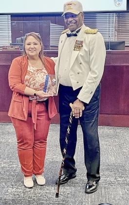Commission Chairman Viviana Janer presents the Lt. Lloyd Burton, Jr. Service Award to veteran Dr. R. LeWayne Johnson Monday.
