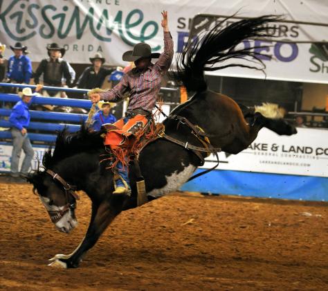 A saddle bronc rider makes it look easy during Saturday night's sellout Silver Spurs Rodeo performance. PHOTO/KATIE WILLIAMS