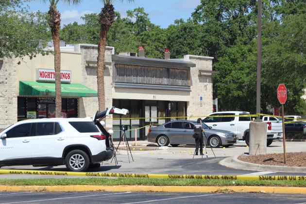 One person is dead -- the second gun fatality in Kissimmee Thursday -- and two others are injured after a shooting Thursday in front of Mighty Wings at Vine Street and Orange Blossom Trail. PHOTO/KEN JACKSON