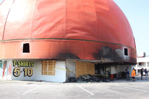 The fire at a partially boarded-up back of Orange World in the light of day Wednesday. PHOTO/KEN JACKSON