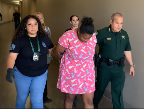 Rachelle Edwards, accused of sexual relations with a juvenile at a detention center she worked at, is led to jail Tuesday. PHOTO/OSCEOLA CO. SHERIFF’S OFFICE