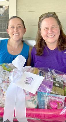 Ashley Call (left) with Lesley Scott, director of Osceola County’s Guardian Ad Litem program, with one of the care-package baskets Legacy’s Gift offers foster parents in need. SUBMITTED PHOTO