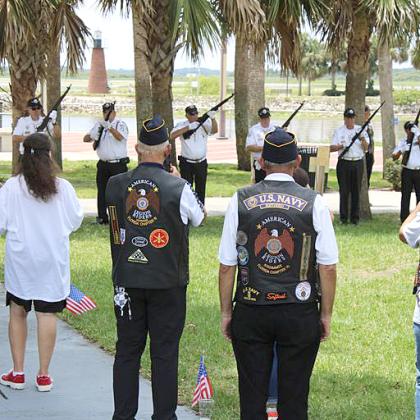 The Osceola County Veterans Council Honor Guard fires a 21-gun salute at Amercian Legion Post 10 on Monday.  PHOTO/TERRY LLOYD