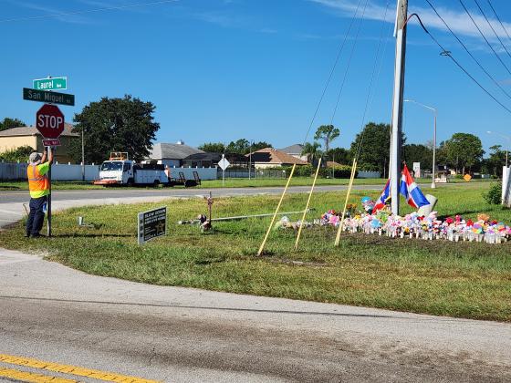 Drivers on Laurel Avenue see the tribute to the four people who died in the crash, and are instructed the intersection is now a four-way stop. PHOTO/KEN JACKSON