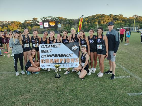 The celebration girls' cross country victory at the OBC meet helped put the Storm in a second-place tie in the standings, one point behind defending champion Harmony. PHOTO/DAN PEARSON