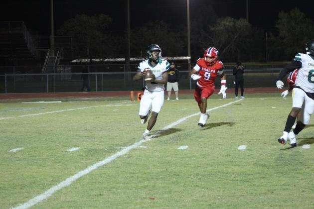 Poinciana defensive end Jason Batista chases Liberty quarterback Jeremiah Pierre-Louis. PHOTO/KEN JACKSON