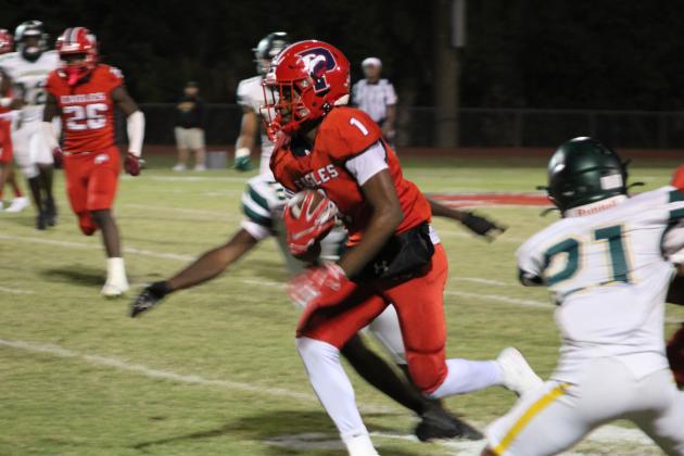 Poinciana's Ernest Nunn weaves through the Liberty secondary after a catch in Friday's victory. PHOTO/KEN JACKSON