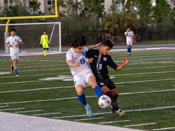 Osceola's Kevin Leiva and Celebration's Euclides Sebastiani fight for the ball. PHOTO/MARIO CASAMALHUAPA