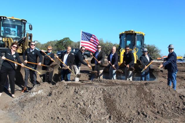 Osceola School District, Schenkel Shultz and Williams Company construction officials participate in Friday's ceremonial groundbreaking for a new K-8 school slated to open in Kindred in 2025. PHOTO/KEN JACKSON