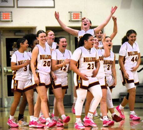 Danigzy Mantilla (23) and Emily Lockey (20), shown with the team in happier times after winning the district championship, led the St. Cloud Bulldogs Monday with 17 and 16 points respectively. PHOTO/KATIE WILLIAMS