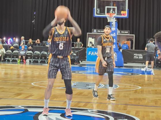Chris Walker (6) and Alex Morales (11) show off the commemorative Osceola Ranchers uniforms Monday during their 120-116 win over the Toronto Raptors 905 Monday at the Silver Spurs Arena. PHOTO/KEN JACKSON