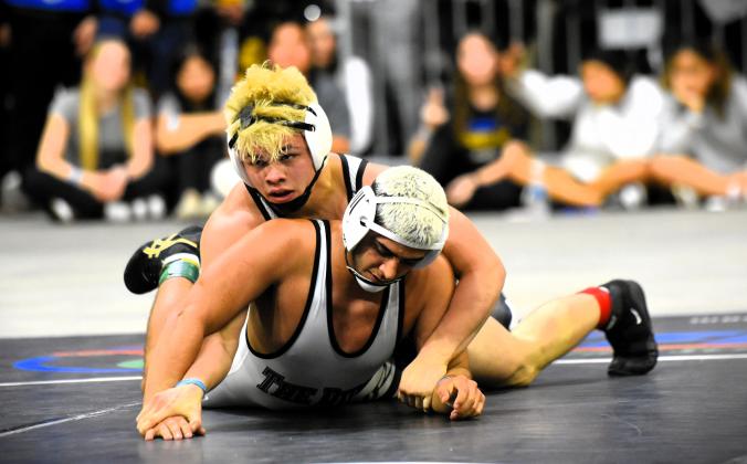 Harmony wrestler Shawn McCallister wraps up a dominating 14-7 win over Palmetto Ridge’s Demetri Zertopoulis in the 157-pound final at the Class 3A FHSAA wrestling championship Saturday at the Silver Spurs Arena. PHOTO/KATIE WILLIAMS