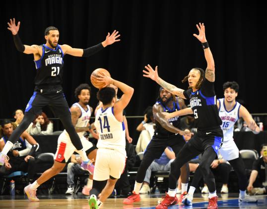 Helter skelter: Osceola's Trevelin Queen (21), D.J. Wilson (5) and Kevon Harris (8) try to shut down Long Island guard's Jacob Gilyard's passing lanes in Friday's NBA G League Eastern Conference semifinal. PHOTO/KATIE WILLIAMS