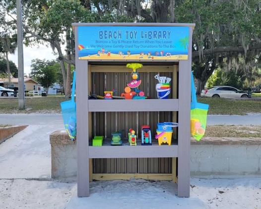SUBMITTED PHOTO The Beach Toy Library, an idea of St. Cloud resident Jacqueline Cruz, is up and running at the Lakefront Park beach, teaching children and families to share.