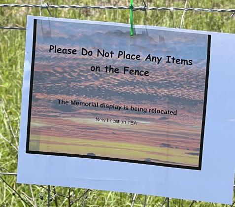A sign on the fence where the memorial was asks the public not to leave more items. SUBMITTED PHOTO