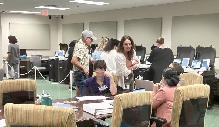Members of the canvassing board and Supervisor of Elections staff test voting machines Saturday. PHOTO/TERRY LLOYD