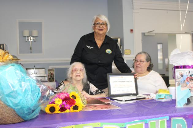 Kissimmee Mayor Olga Gonzalez presents a Certificate of Appreciation to Palma Tessler, who celebrated her 109th birthday Friday at the Osceola Council on Aging. PHOTO/TERRY LLOYD