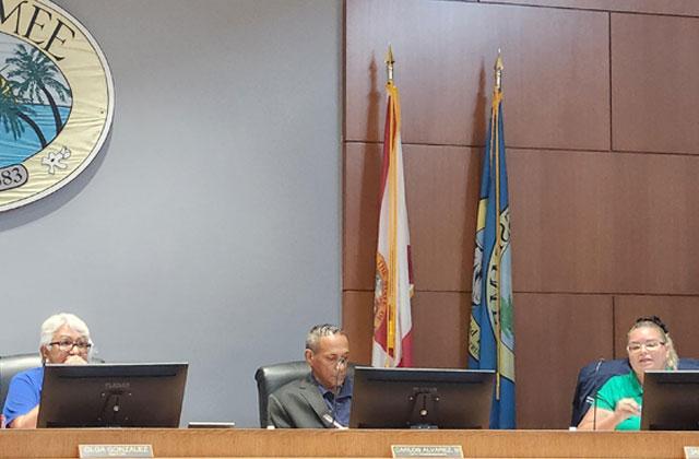 Kissimmee City Commissioner Janette Martinez (right) who called a meeting about the city's campaign sign ordinance at the Civic Center, discusses how to deal with a stack of complaints from opposing candidates. PHOTO/KEN JACKSON
