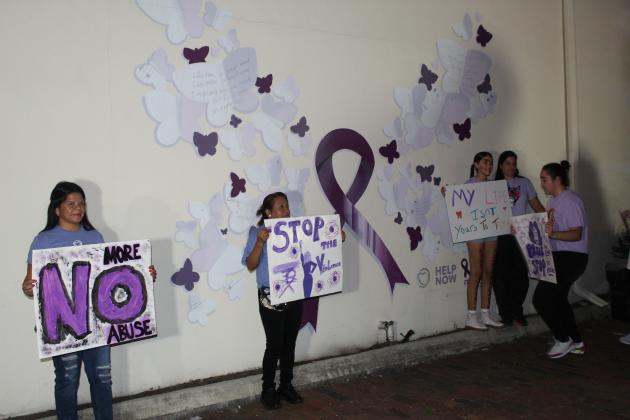 During the march from the Courthouse to Kissimmee Police Department, the procession stopped at a mural dedicated to domestic violence victim Nicole Montalvo. PHOTO/KEN JACKSON