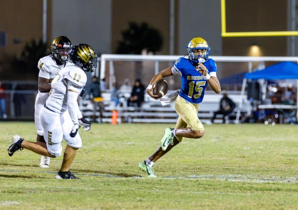 Osceola quarterback Camren West tossed two touchdown passes Friday, and helped move the chains with his feet. PHOTO/TAYLOR MCFEE