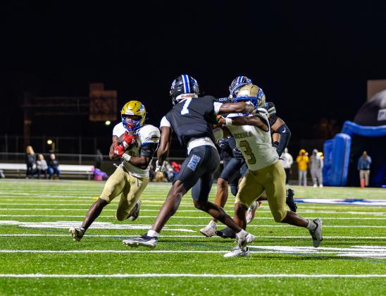 Osceola's Alijah Jenkins (3) throws a block for Taevion Swint, who gained 139 yards and scored the Kowboys' two touchdowns, in a hard-fought 17-7 win over Armwood in the Region 6A-2 championship Friday. OHS moves onto the state semifinals. PHOTO/TAYLOR MCFEE