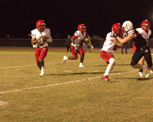 Poinciana quarterback Cameron Brown looks for a receiver downfield in the Eagles' 35-14 bowl game win Wednesday at East River. PHOTO/ANDY SURUJDYAL